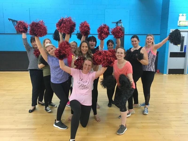 Hen party squad with pom-poms at a cheerleading dance class in Exeter